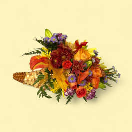Mixed bouquet in a woven cone with orange, red, and purple flowers