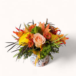 Autumn bouquet with peach roses and yellow chrysanthemums in a floral box