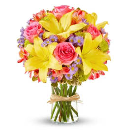 Bouquet of pink roses, yellow lilies, and purple daisies in a glass vase