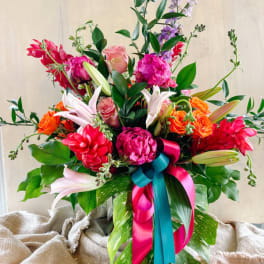 Bright mixed bouquet with pink, orange, and white flowers in a vase