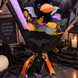 Halloween bouquet with a plush black bat and orange roses in black wrapping