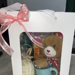 Gift box with a teddy bear, mug, and candy