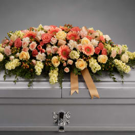 Large floral casket spray with pink and cream roses and gerbera daisies
