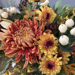 Mixed bouquet with orange and yellow chrysanthemums and white berries