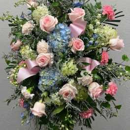 Tall pastel floral standing spray with pink roses and blue hydrangeas