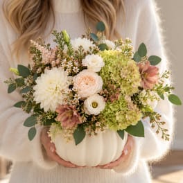 Mixed bouquet in a white pumpkin vase with cream, blush, and green blooms