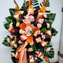 Large floral standing spray with pink and orange roses and carnations