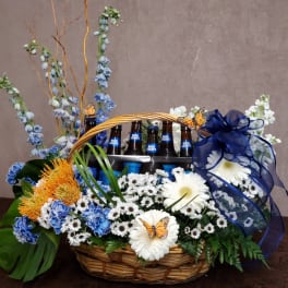 Basket arrangement with flowers and Bud Light bottles, tied with a blue ribbon