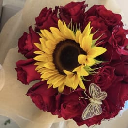 Bouquet of red roses with a yellow sunflower and butterfly decoration