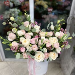 Pink and white rose bouquet in a white hat box with ribbon