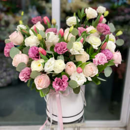 Pink and white bouquet in a white hatbox with ribbon