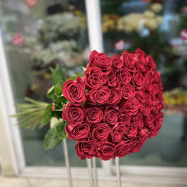 Large bouquet of red roses on tall stands