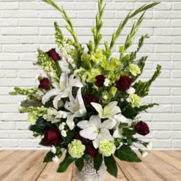 White lilies and burgundy roses in a decorative vase