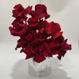 Bouquet of deep red roses in a white container