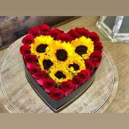 Heart-shaped box of red roses and yellow sunflowers
