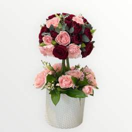 Two-tier rose arrangement in a textured white vase