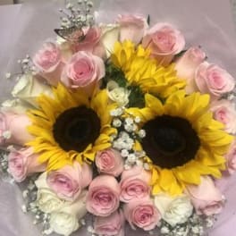 Bouquet of pink roses and sunflowers with baby's breath