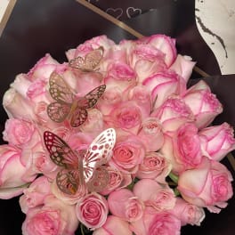 Pink rose bouquet with butterfly picks and a Happy Anniversary sign