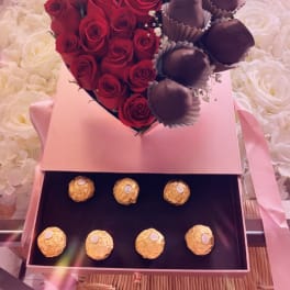 Heart-shaped box with red roses, chocolate-covered strawberries, and Ferrero Rocher chocolates