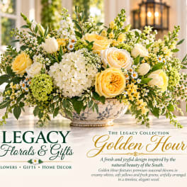 Yellow and white floral arrangement in a decorative bowl