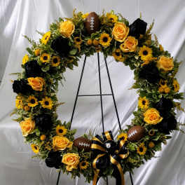 Football-themed floral wreath with yellow roses and sunflowers