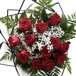 Bouquet of red roses with white baby's breath and fern foliage