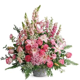 Pink lilies and roses in a gray vase