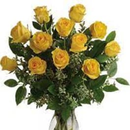 Arrangement of yellow roses in a clear glass vase