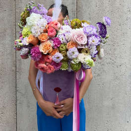 Large bouquet of multicolored roses and lisianthus with ribbon streamers