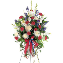 Standing floral spray with red, white, and blue flowers on an easel
