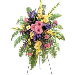 Standing floral spray with pink, yellow, and purple flowers on an easel