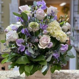 Lavender and white rose arrangement in a wooden box
