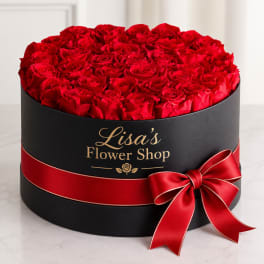 Round box filled with red roses and tied with a red ribbon