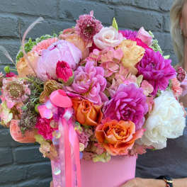 Pink and orange mixed bouquet in a pink box with ribbon