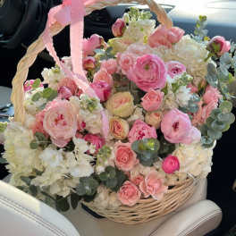 Pink and white flower basket with a ribbon handle