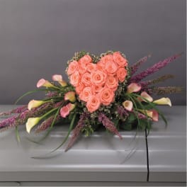 Heart-shaped bouquet of peach roses with pink calla lilies