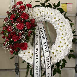 Red and white funeral wreaths with ribbon streamers