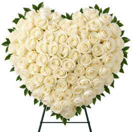 Heart-shaped arrangement of white roses on a stand