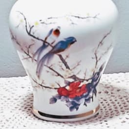 White ceramic vase with painted birds and blossoms