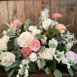 Pastel rose arrangement with white and pink blooms in a low design
