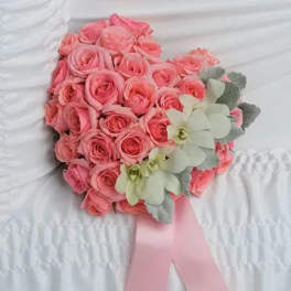 Pink rose bouquet with pale green orchids and a pink ribbon