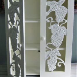 Decorative white cabinet with carved fish panels