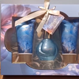 Gift set with two blue lotion tubes and a blue perfume bottle in a box
