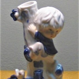 Ceramic figurine of a child hugging a dog