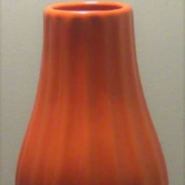 Orange ceramic vase with a tapered, rounded shape