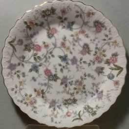Decorative white scalloped plate with pastel floral pattern