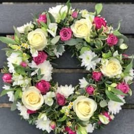Floral wreath with cream and pink roses and white daisies