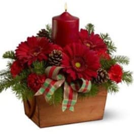 Red candle centerpiece with red flowers in a wooden box