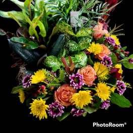 Mixed bouquet with peach roses, yellow mums, and purple daisies