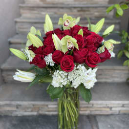 Red roses and white lilies in a clear glass vase